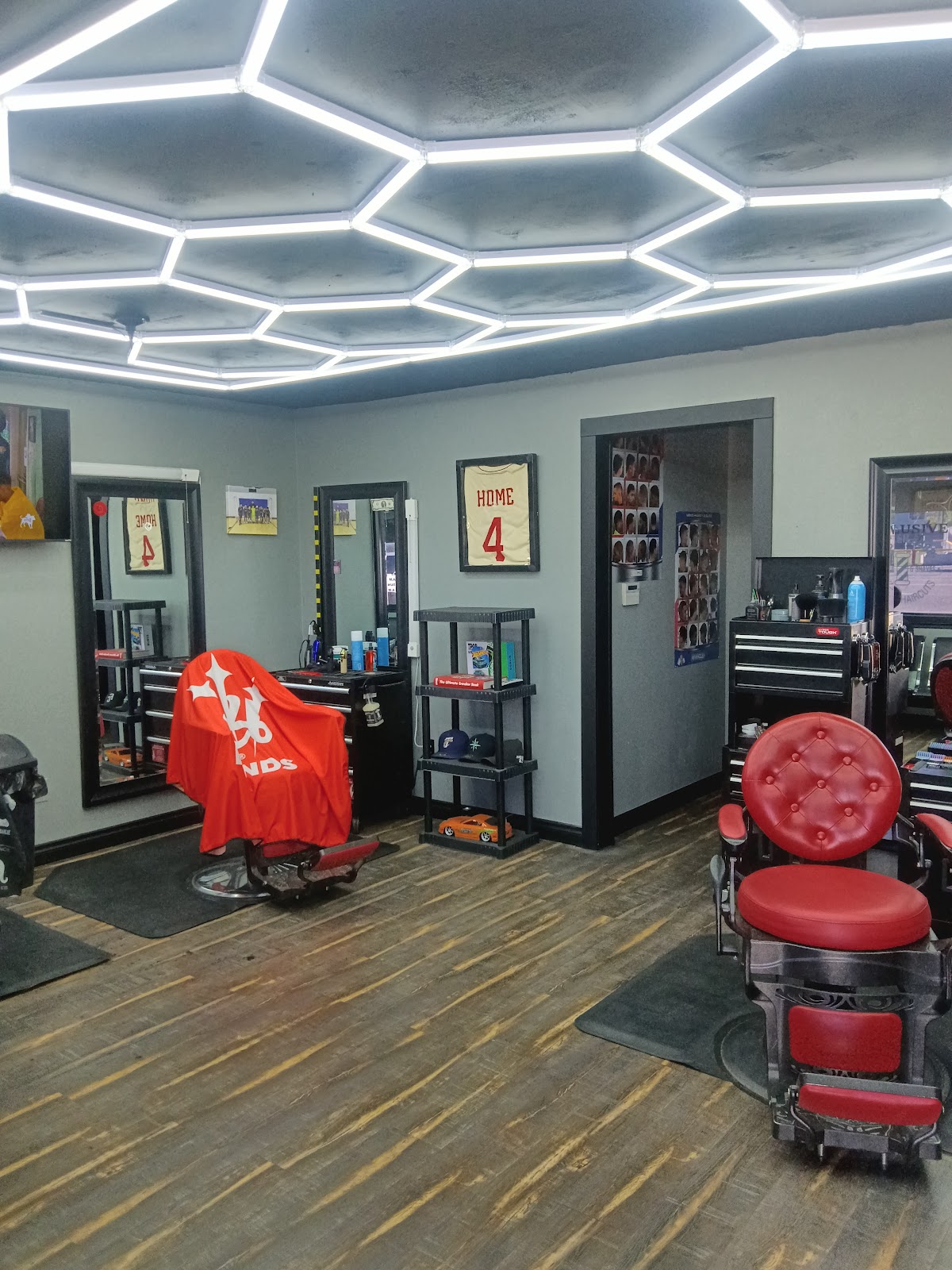 Inside Exclusive Barbershop, red chairs and hexagon LED ceiling